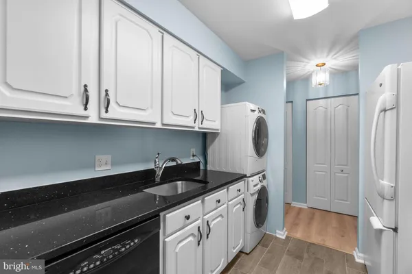 a utility room with sink dryer and washer