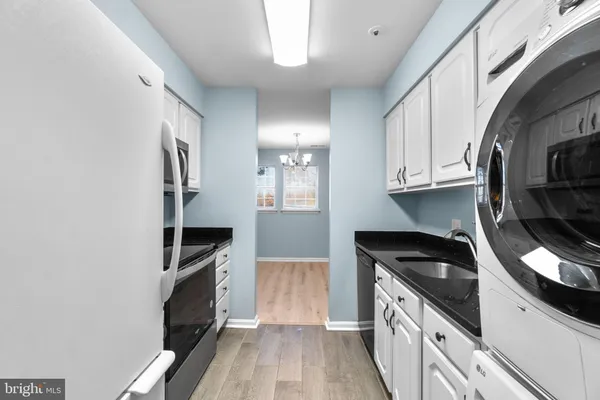 a view of a room with wooden floor and a ceiling fan
