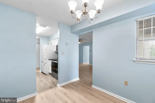 a kitchen with stainless steel appliances granite countertop a refrigerator a stove and a microwave