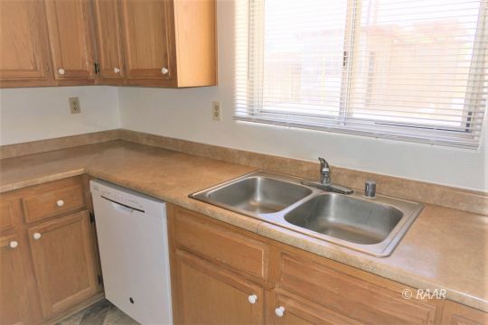 229 North Helena Street Ridgecrest, CA 93555 - Photo 10 of 32 a kitchen with a sink cabinets and window
