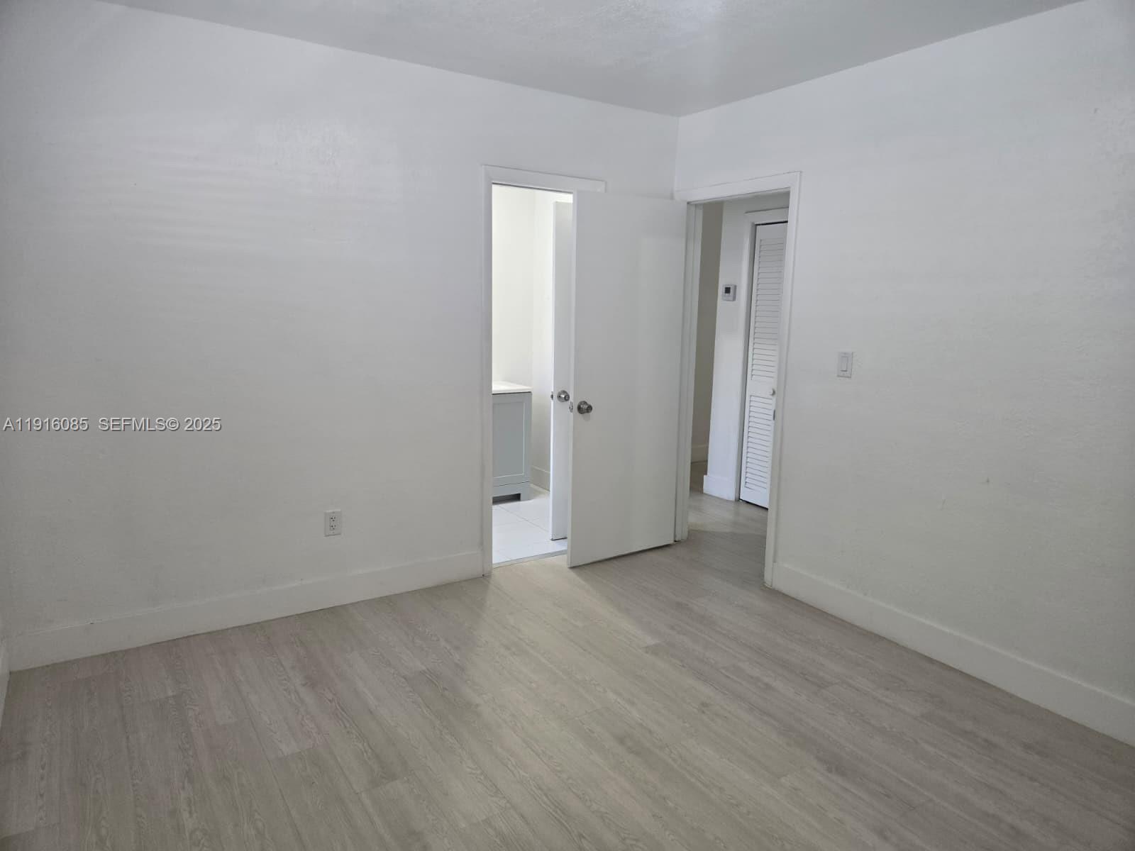 637 West 31st Street Hialeah, FL 33012 - Photo 14 of 20 a view of an empty room with wooden floor and closet