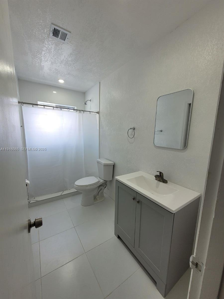 637 West 31st Street Hialeah, FL 33012 - Photo 15 of 20 a bathroom with a sink toilet and shower