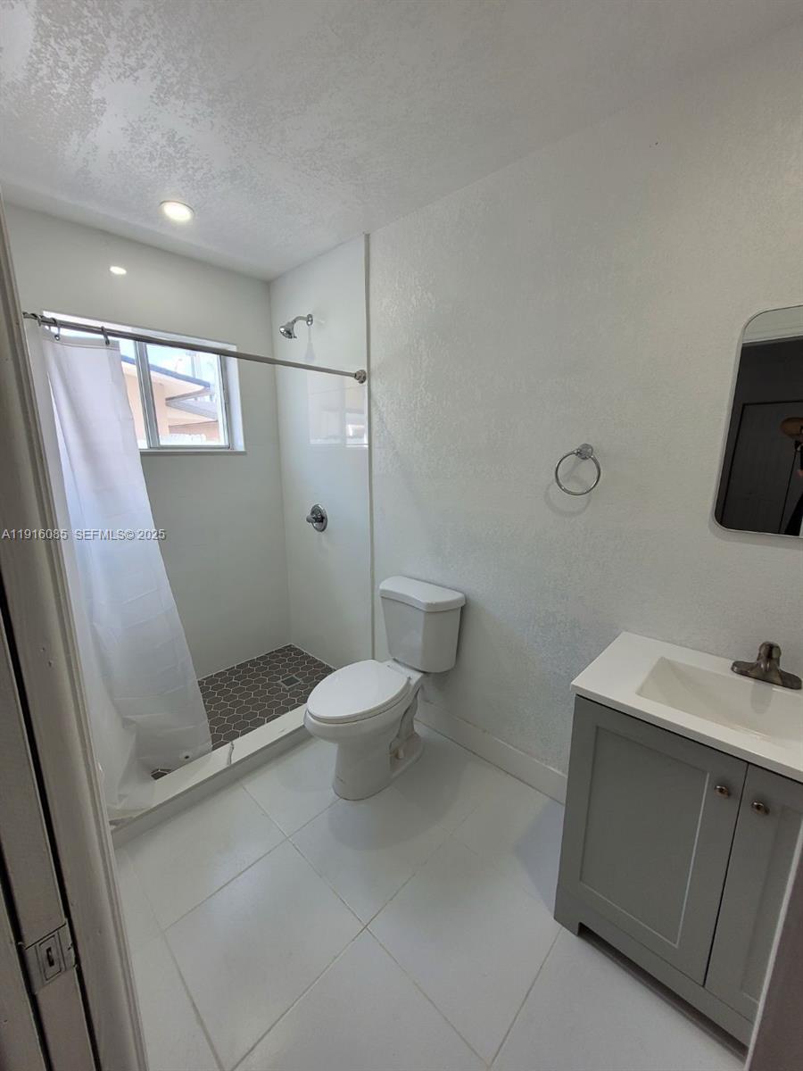 637 West 31st Street Hialeah, FL 33012 - Photo 16 of 20 a bathroom with a sink a toilet and shower