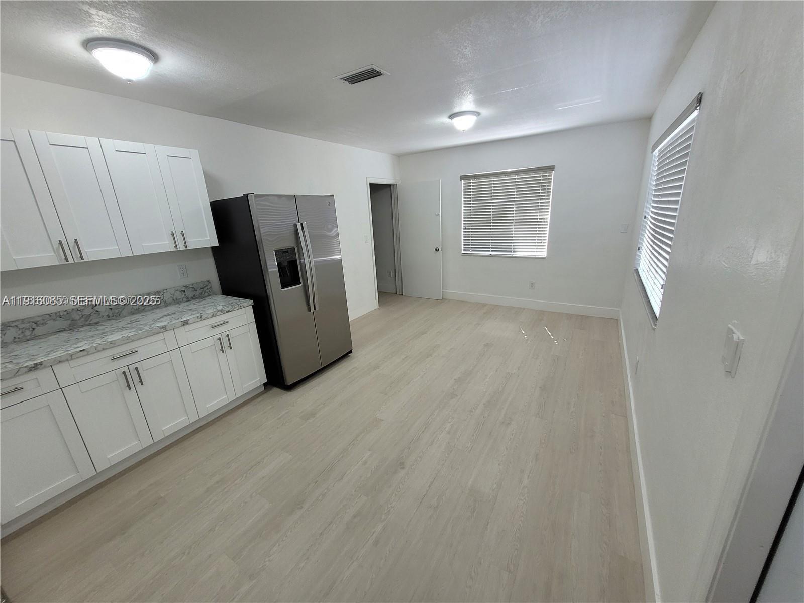 637 West 31st Street Hialeah, FL 33012 - Photo 6 of 20 a view of a kitchen with refrigerator and cabinet