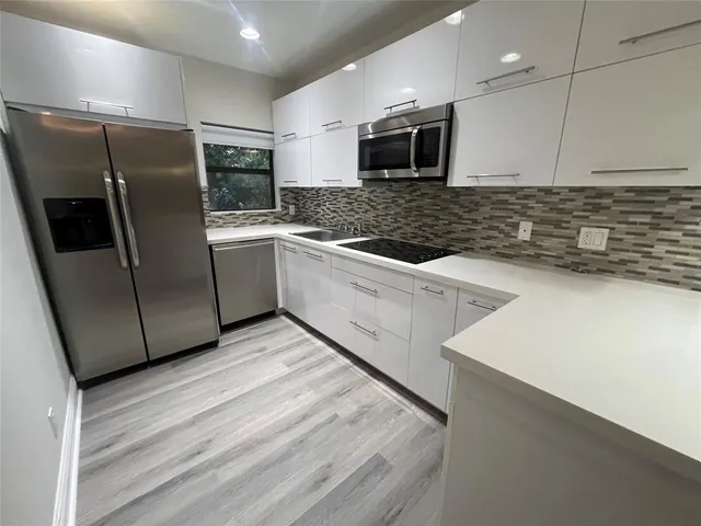 a kitchen with a refrigerator sink and microwave