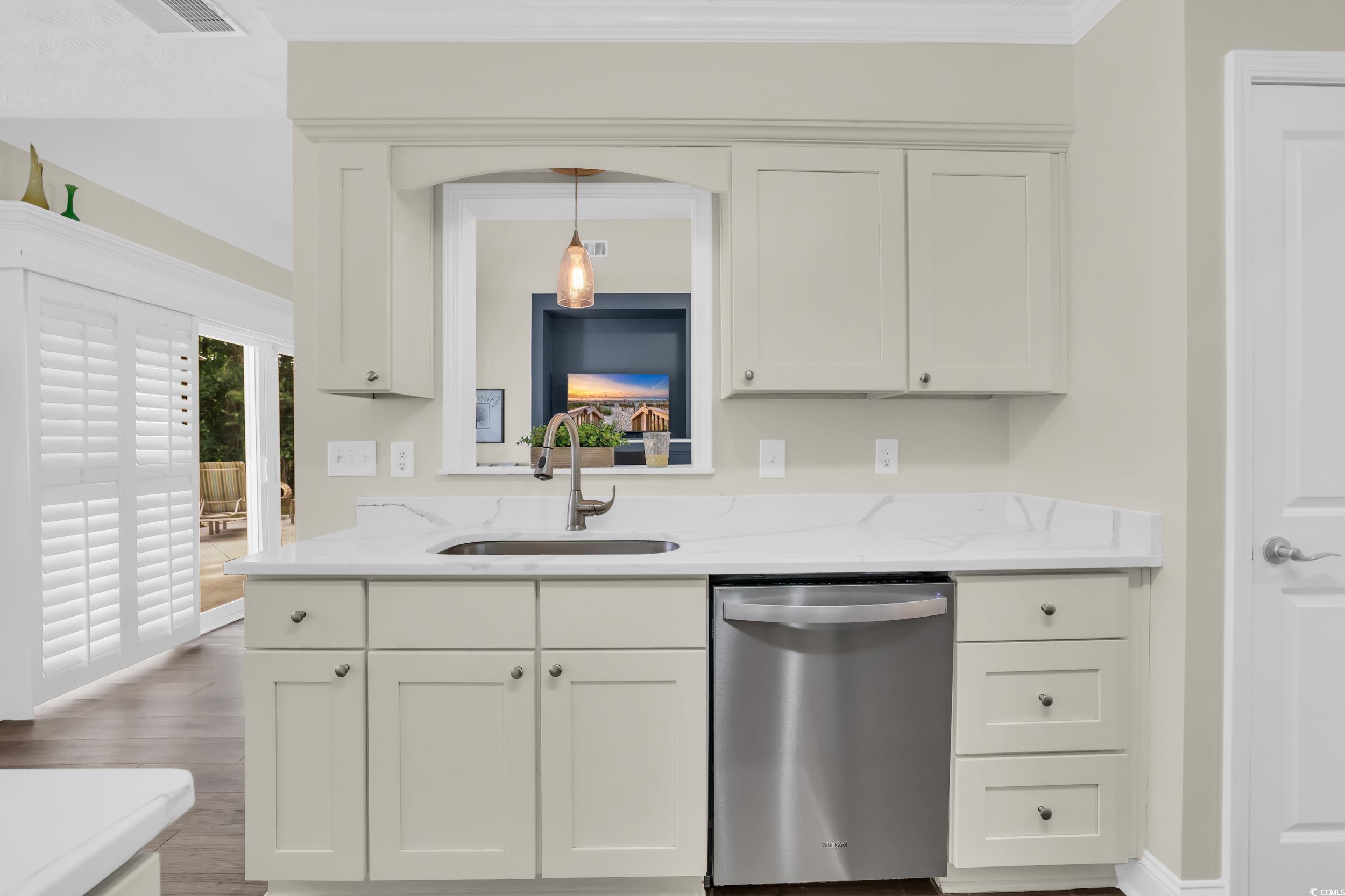442 Deer Watch Circle Longs, SC 29568 - Photo 13 of 40 Kitchen featuring dishwasher, white cabinetry, light stone counters, wood finished floors, and ornamental molding