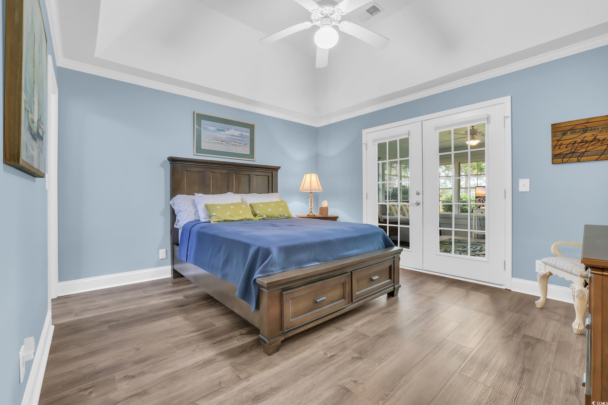 442 Deer Watch Circle Longs, SC 29568 - Photo 22 of 40 Bedroom with access to outside, ornamental molding, a ceiling fan, wood finished floors, and french doors
