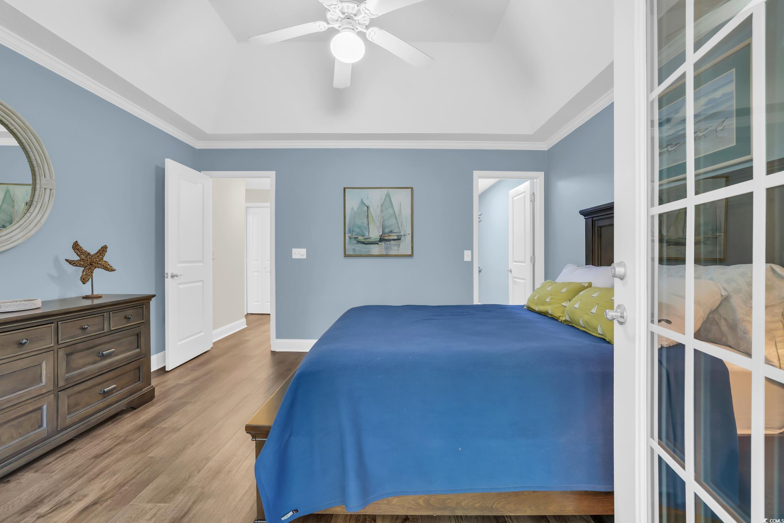 442 Deer Watch Circle Longs, SC 29568 - Photo 23 of 40 Bedroom with wood finished floors, a ceiling fan, and crown molding
