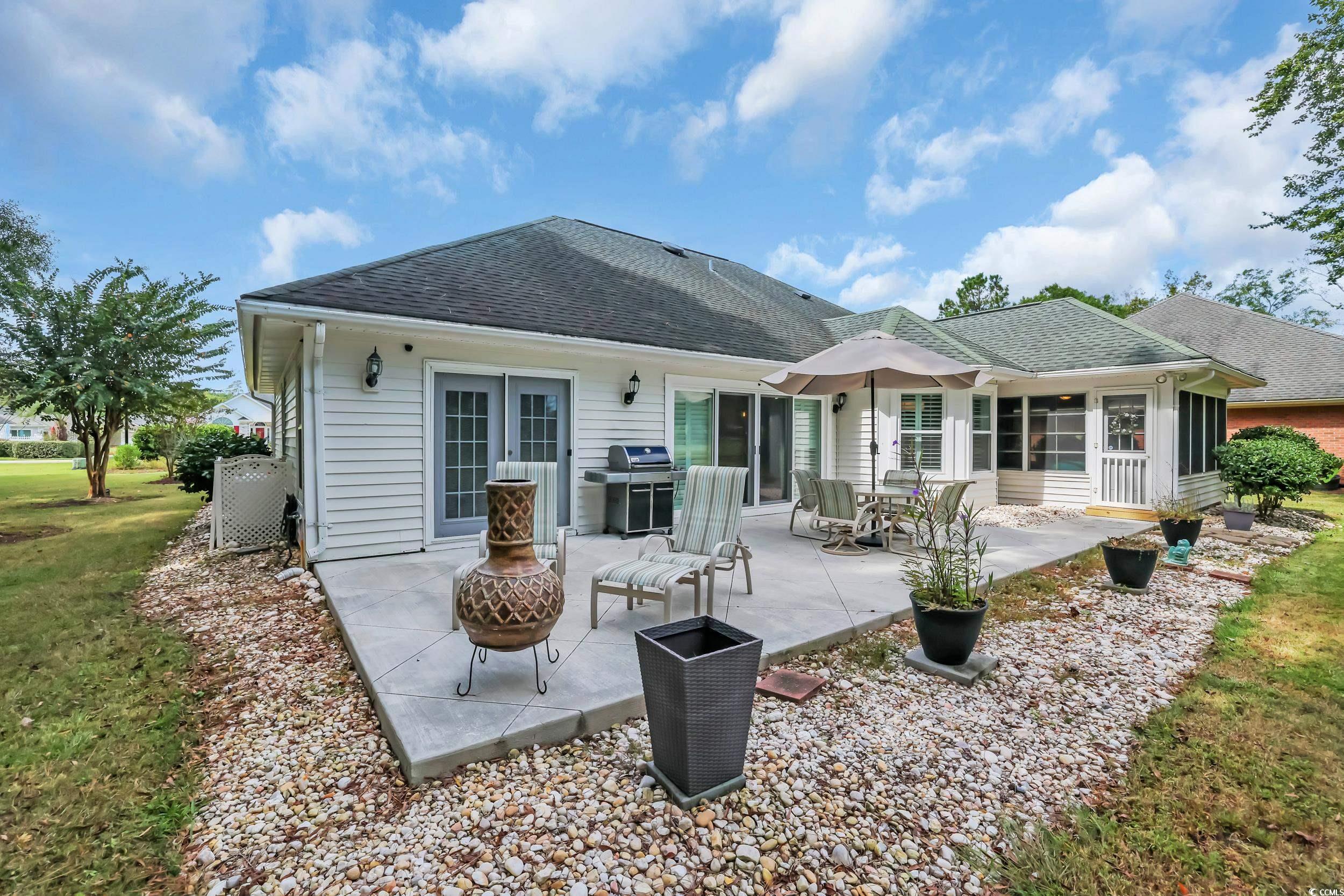 442 Deer Watch Circle Longs, SC 29568 - Photo 26 of 40 Rear view of property featuring a shingled roof, a patio, a sunroom, and a yard