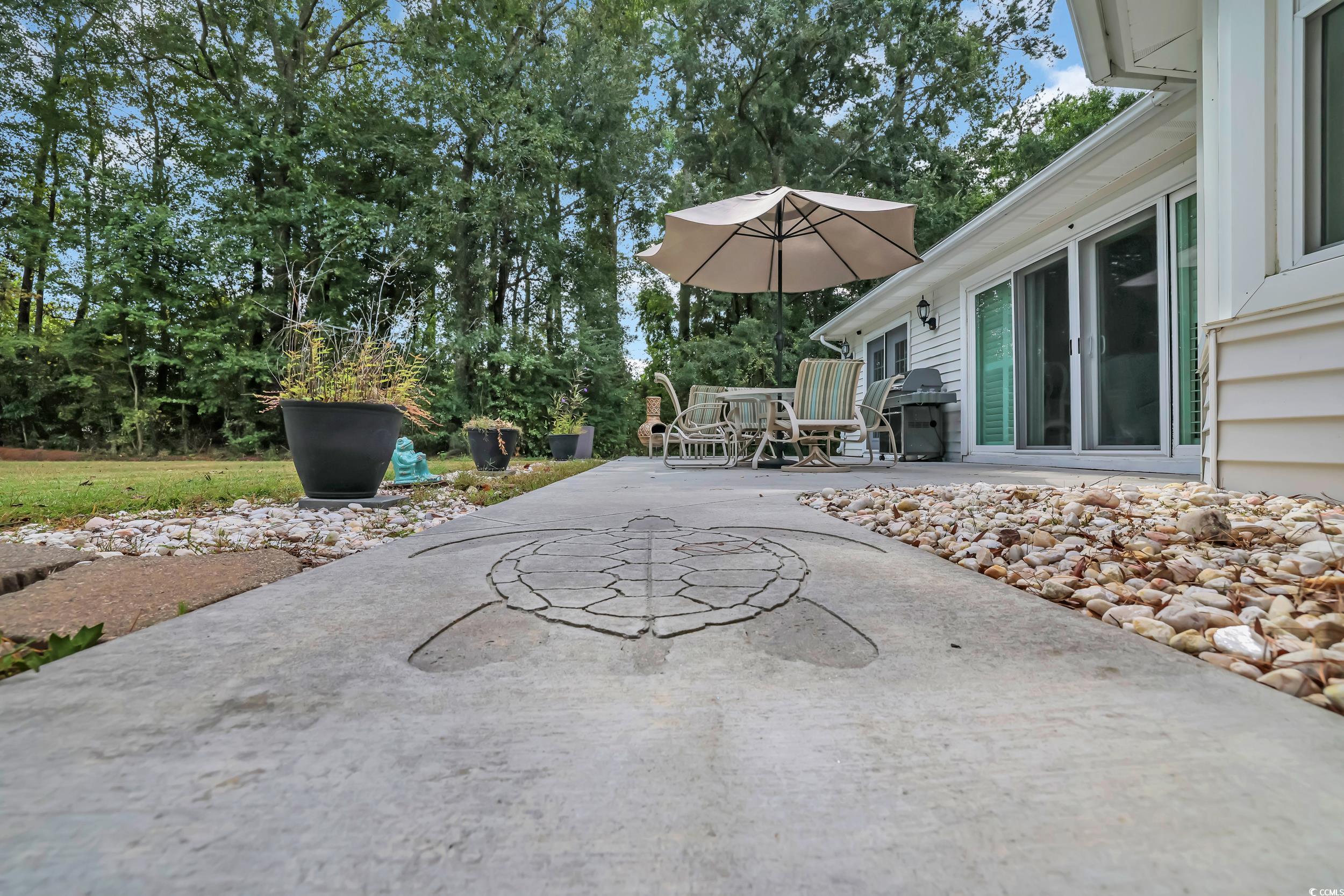 442 Deer Watch Circle Longs, SC 29568 - Photo 29 of 40 View of patio featuring outdoor dining space, a grill, and view of wooded area