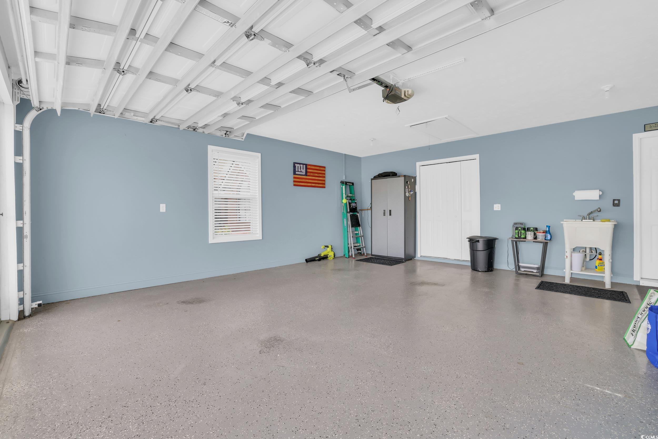 442 Deer Watch Circle Longs, SC 29568 - Photo 31 of 40 Garage featuring a garage door opener and a sink