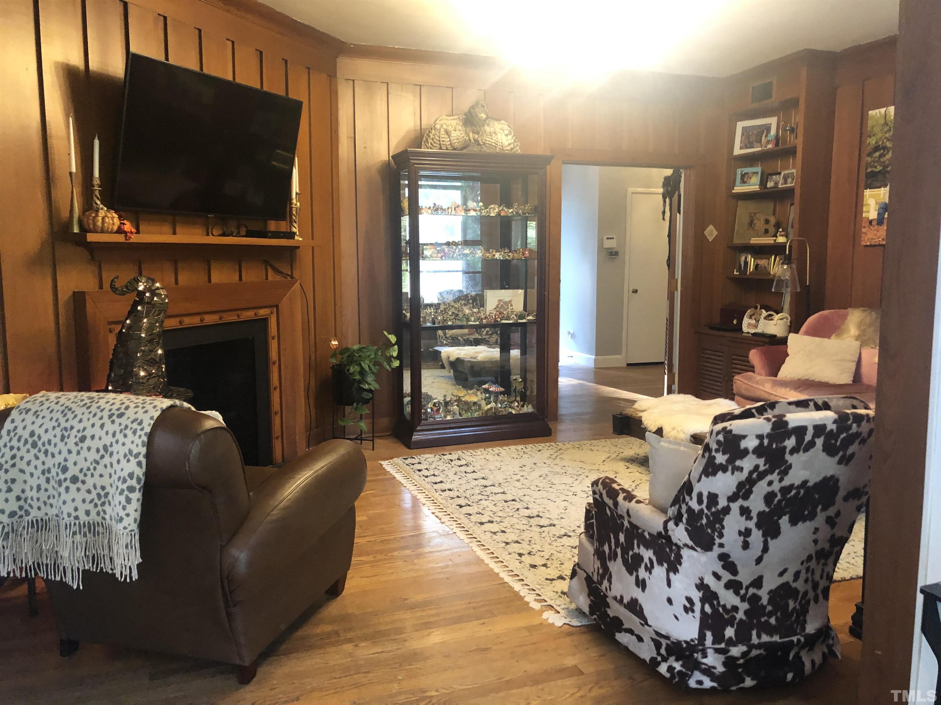 910 Marrow Drive Henderson, NC 27536 - Photo 12 of 30 a living room with furniture a flat screen tv and a fireplace