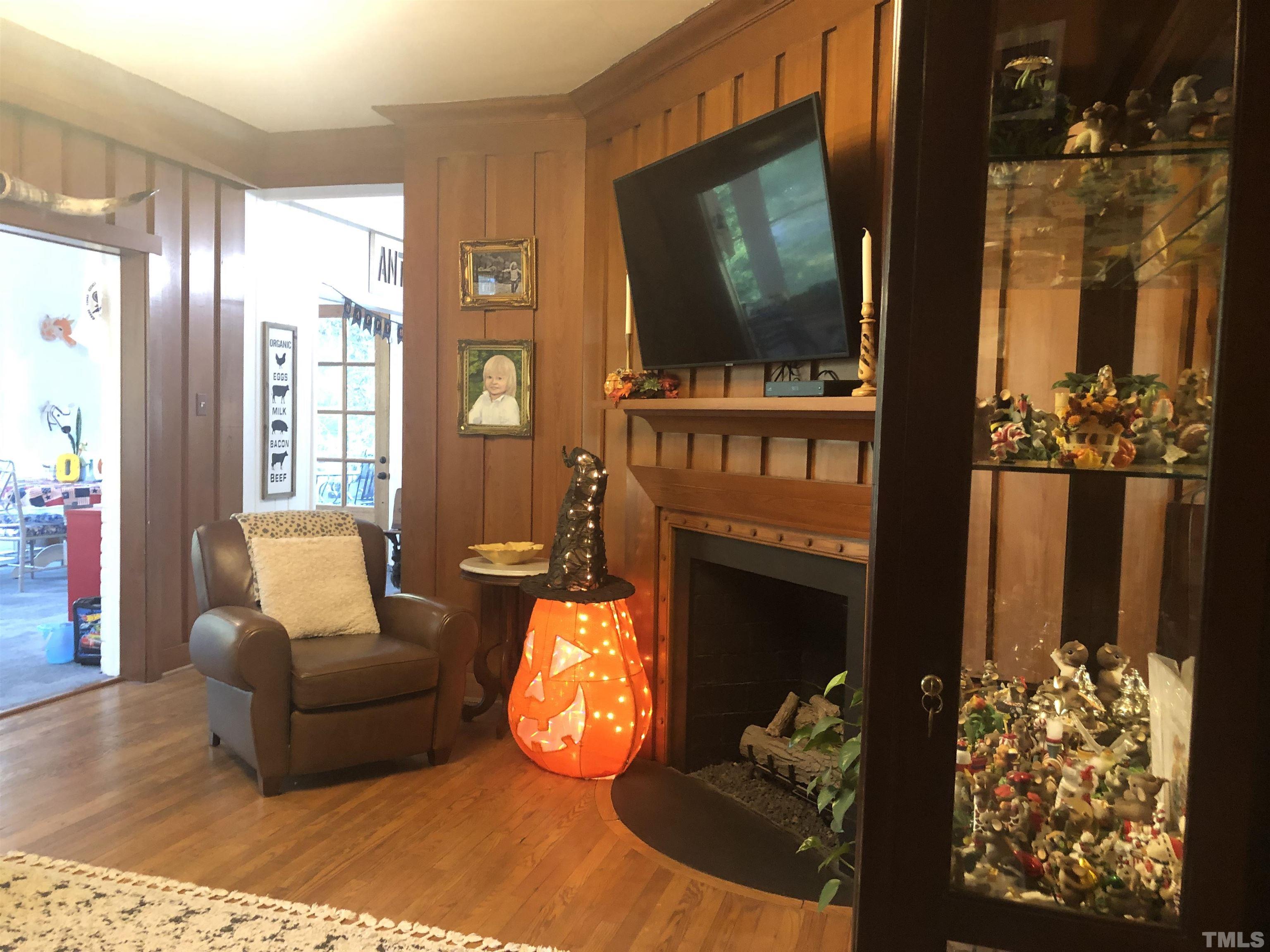 910 Marrow Drive Henderson, NC 27536 - Photo 13 of 30 a living room with furniture a flat screen tv and a fireplace