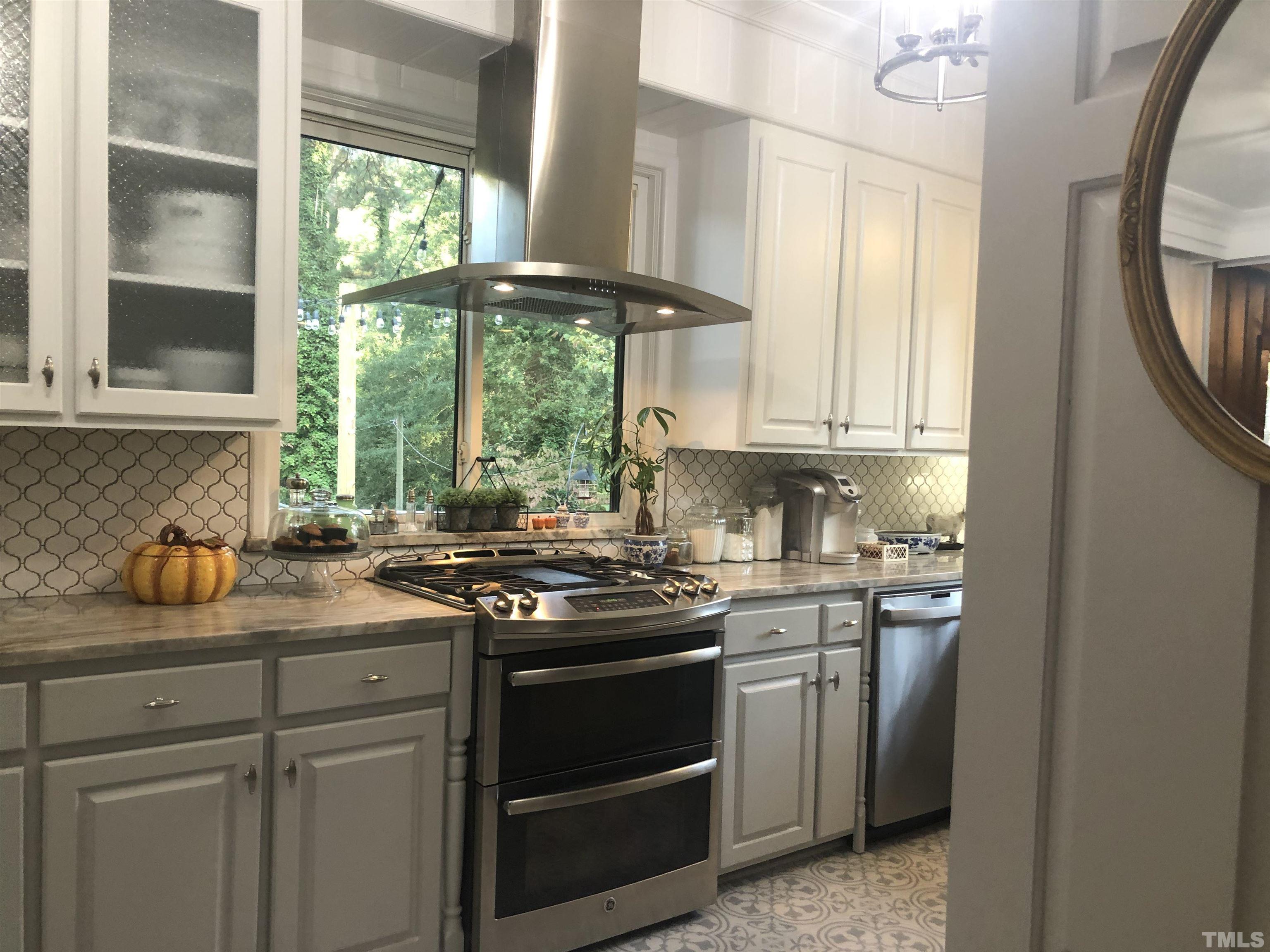 910 Marrow Drive Henderson, NC 27536 - Photo 16 of 30 a kitchen with stainless steel appliances a stove a sink and a window