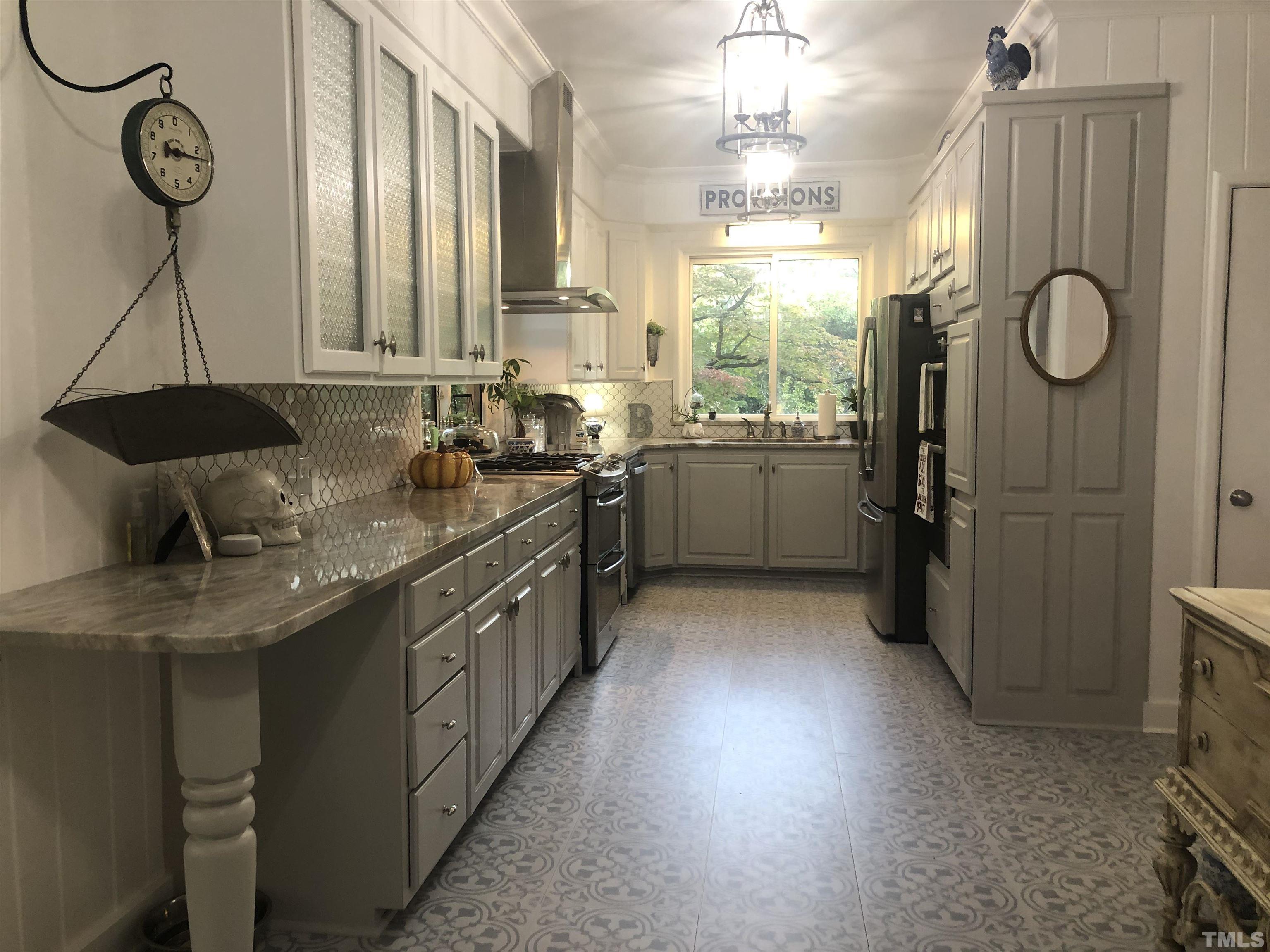 910 Marrow Drive Henderson, NC 27536 - Photo 17 of 30 a kitchen with cabinets and window