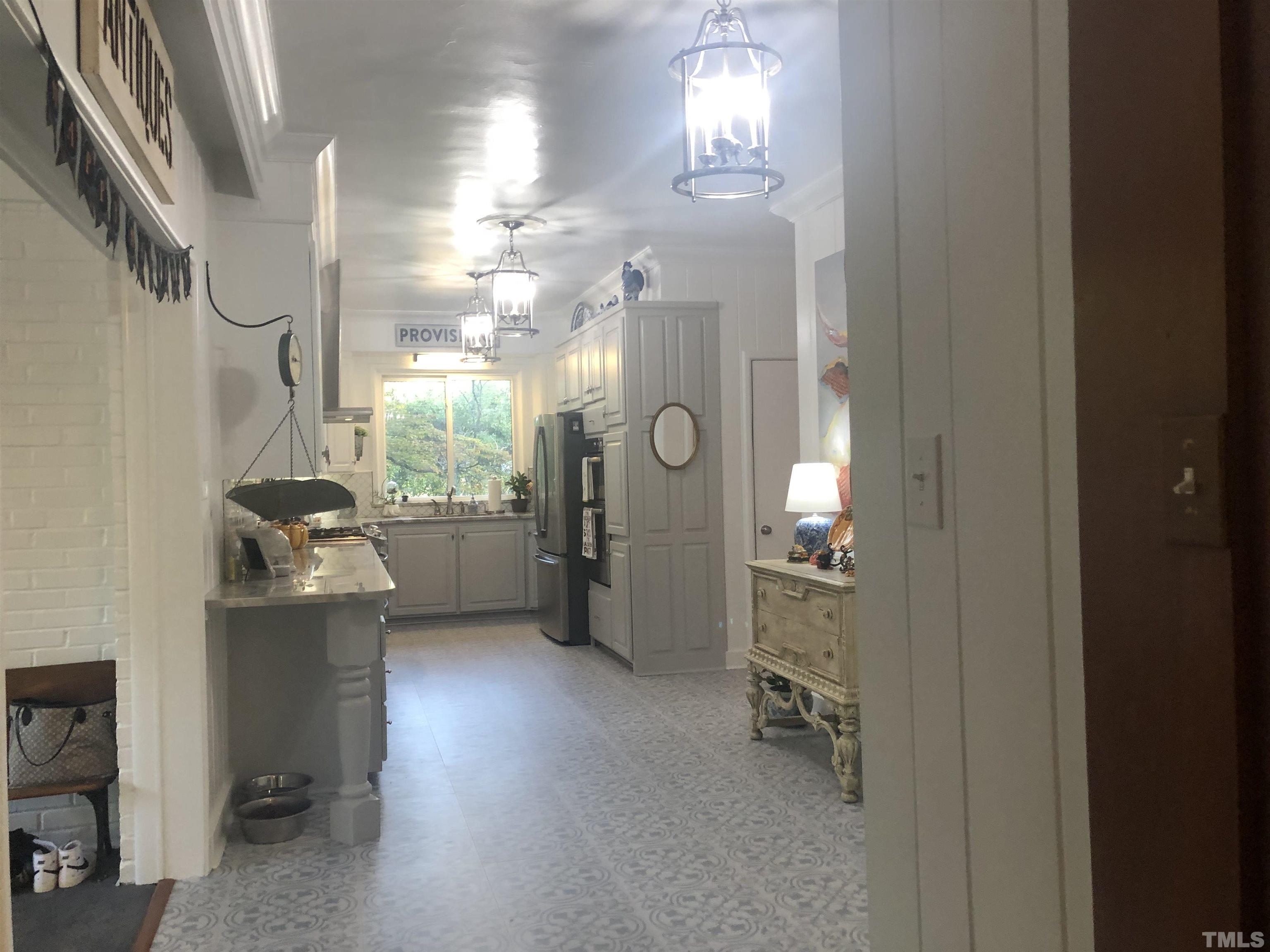 910 Marrow Drive Henderson, NC 27536 - Photo 18 of 30 a kitchen with refrigerator and window