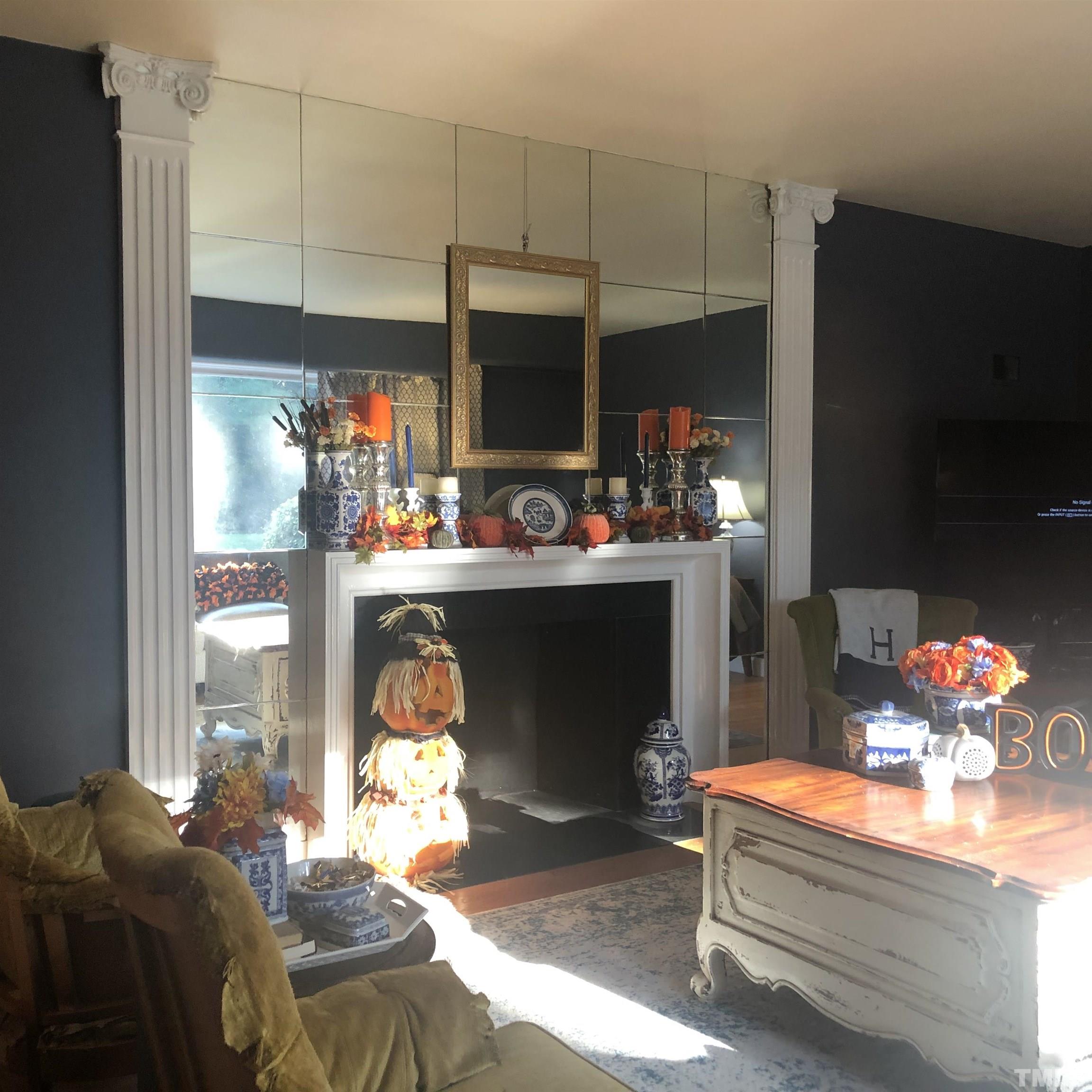 910 Marrow Drive Henderson, NC 27536 - Photo 7 of 30 a living room with furniture a flat screen tv and a fireplace