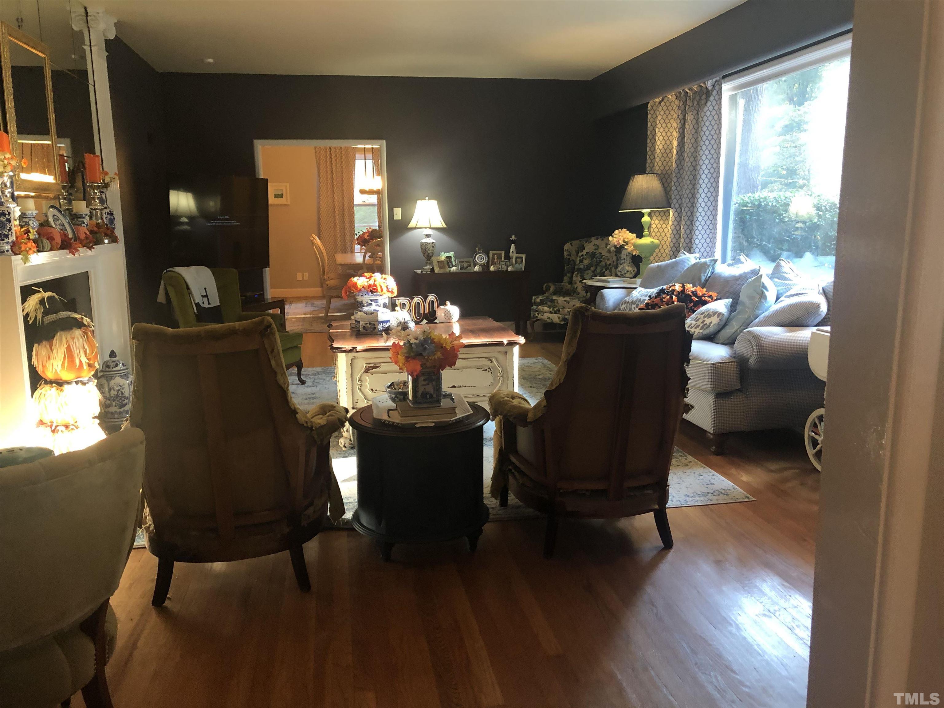 910 Marrow Drive Henderson, NC 27536 - Photo 9 of 30 a dining room with furniture a chandelier and wooden floor