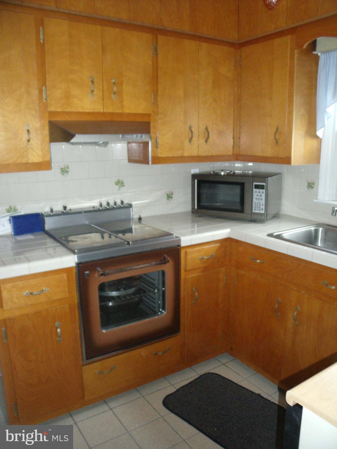 1209 Orems Road Baltimore, MD 21220 - Photo 11 of 29 a kitchen with granite countertop cabinets stainless steel appliances and a counter space