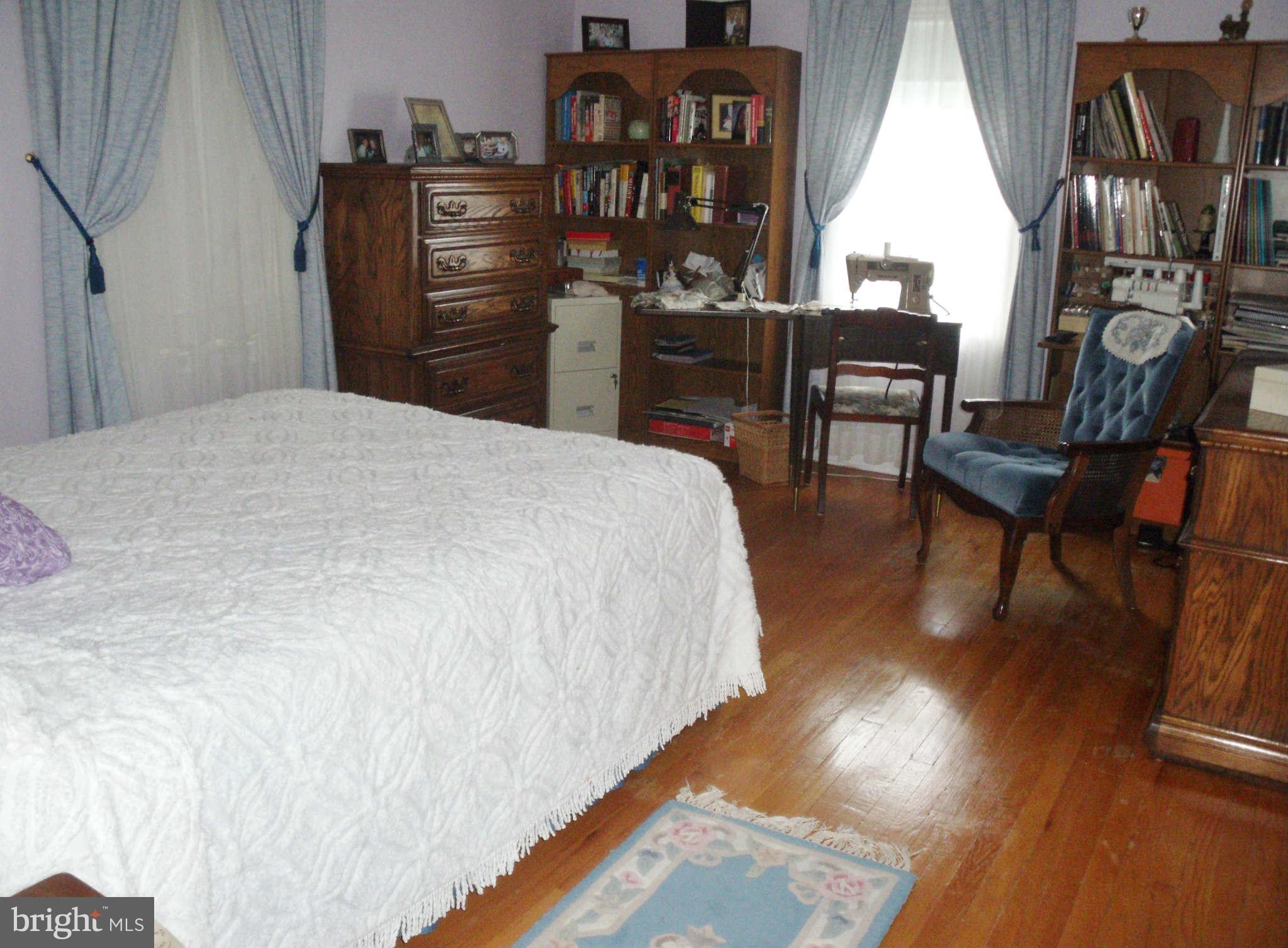 1209 Orems Road Baltimore, MD 21220 - Photo 18 of 29 a bedroom with a bed a table and chair
