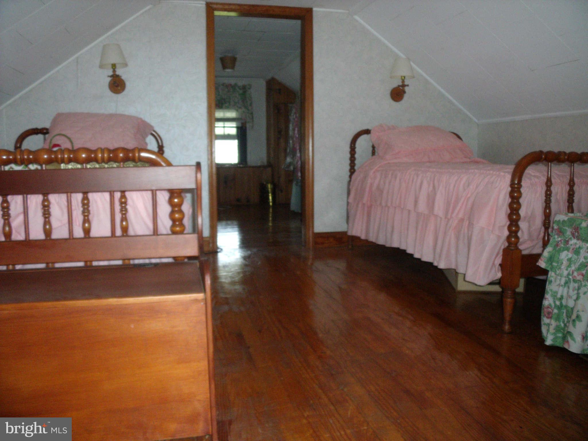 1209 Orems Road Baltimore, MD 21220 - Photo 22 of 29 a view of a bedroom with wooden floor and bed