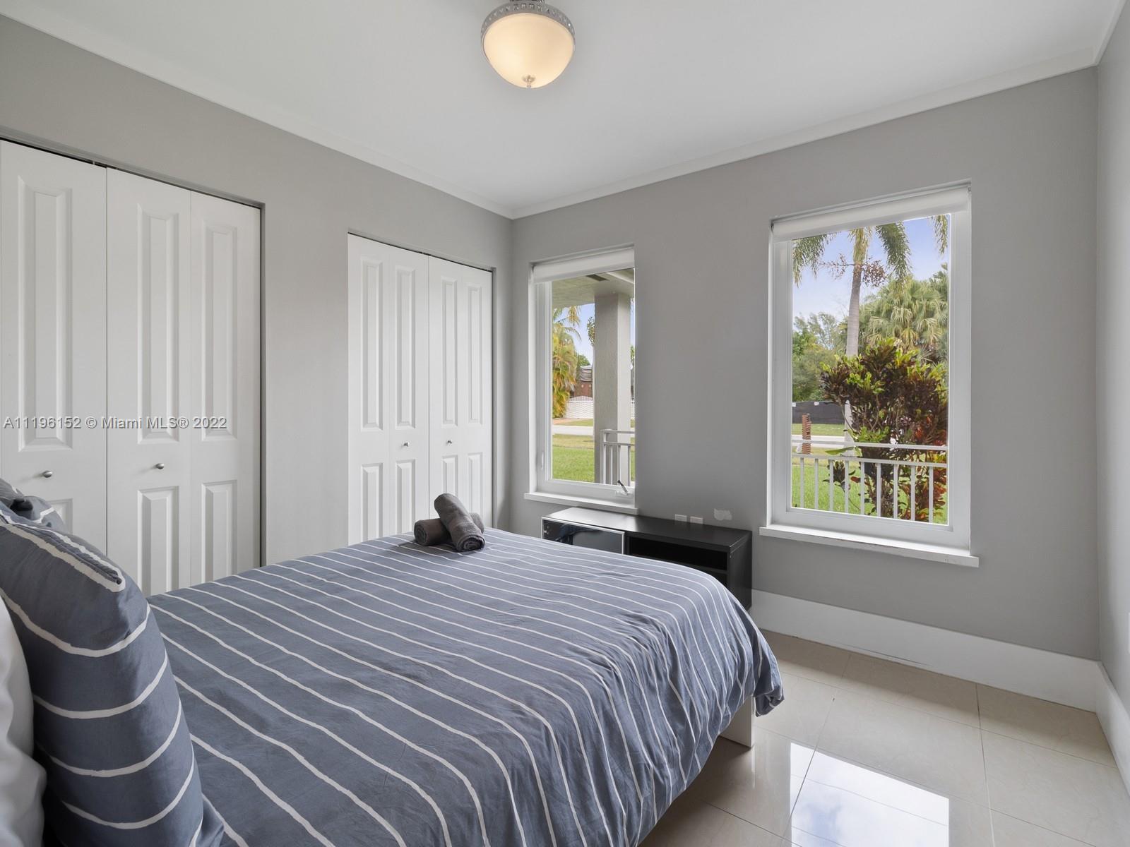 14250 Southwest 97th Avenue Miami, FL 33176 - Photo 23 of 38 a bedroom with a bed and window