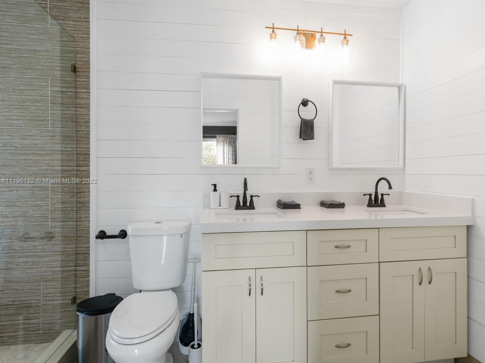 14250 Southwest 97th Avenue Miami, FL 33176 - Photo 30 of 38 a bathroom with a double vanity sink toilet and a mirror