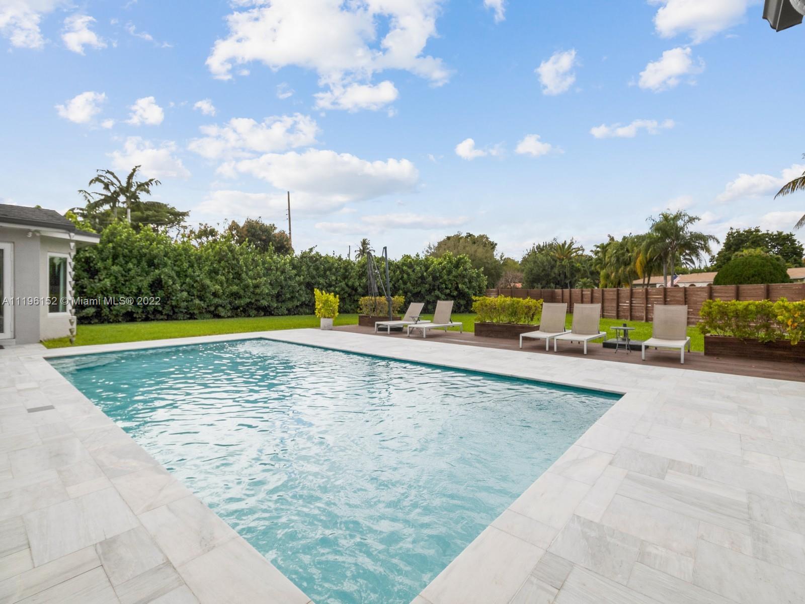 14250 Southwest 97th Avenue Miami, FL 33176 - Photo 33 of 38 a view of a swimming pool and a yard