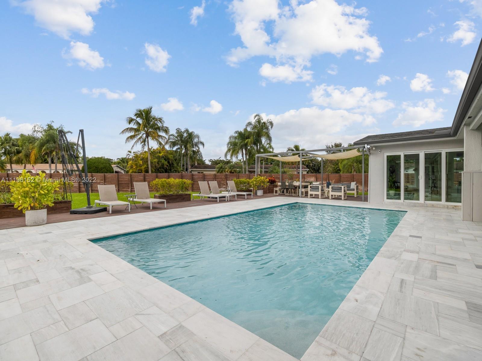 14250 Southwest 97th Avenue Miami, FL 33176 - Photo 34 of 38 a view of a swimming pool with an outdoor seating