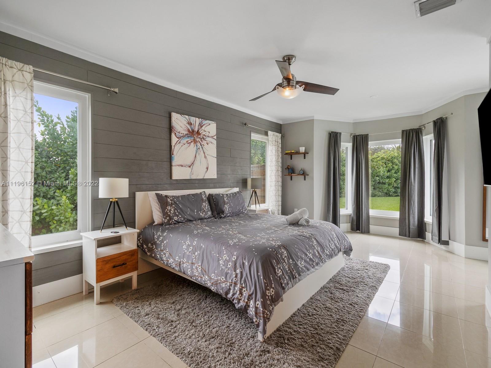 14250 Southwest 97th Avenue Miami, FL 33176 - Photo 4 of 38 a bedroom with a large bed couch and windows