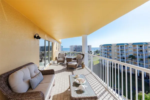a view of a city with lawn chairs and ocean view
