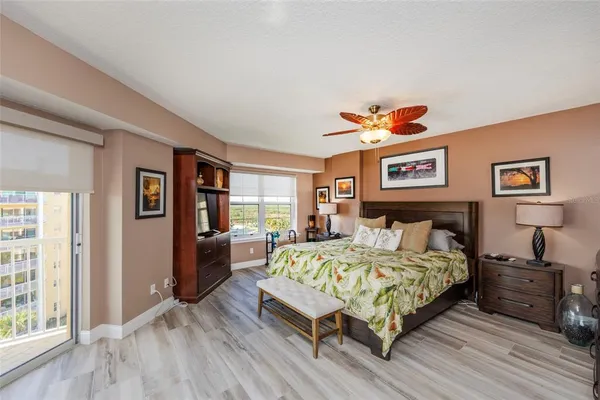 a bedroom with a bed and glass windows