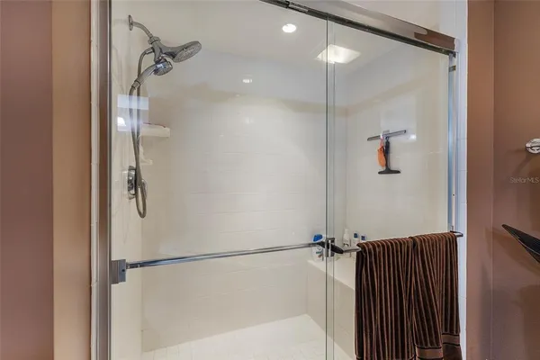 a spacious bathroom with a double vanity sink mirror and bathtub