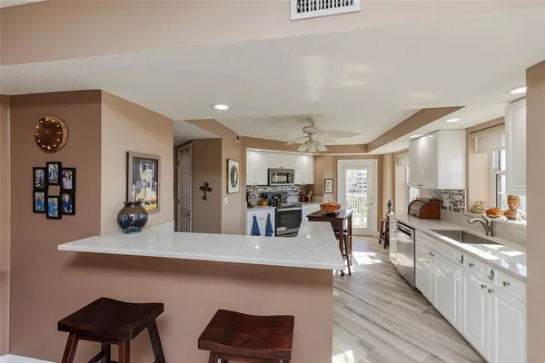 a living room with furniture a flat screen tv and a window