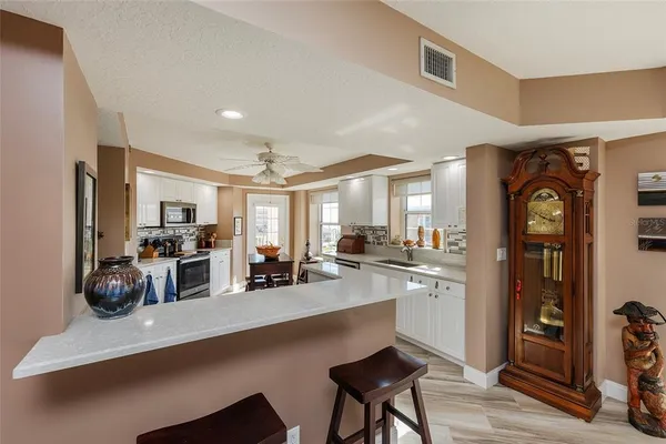 a kitchen with sink stove and refrigerator
