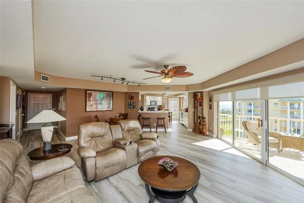 a living room with furniture a rug and a window