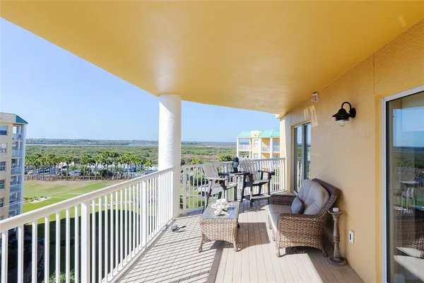 a view of balcony with chairs and iron fence