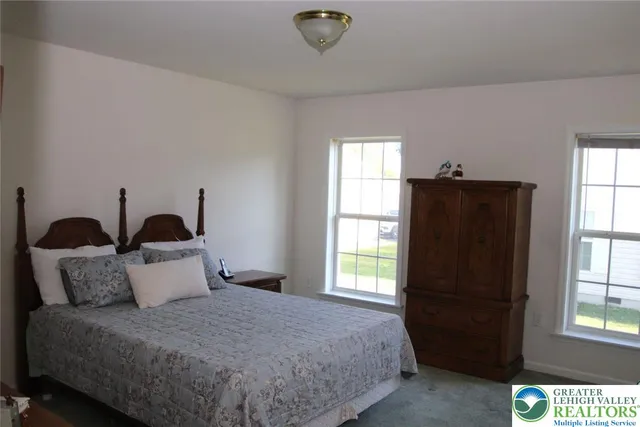 a bedroom with bed and window