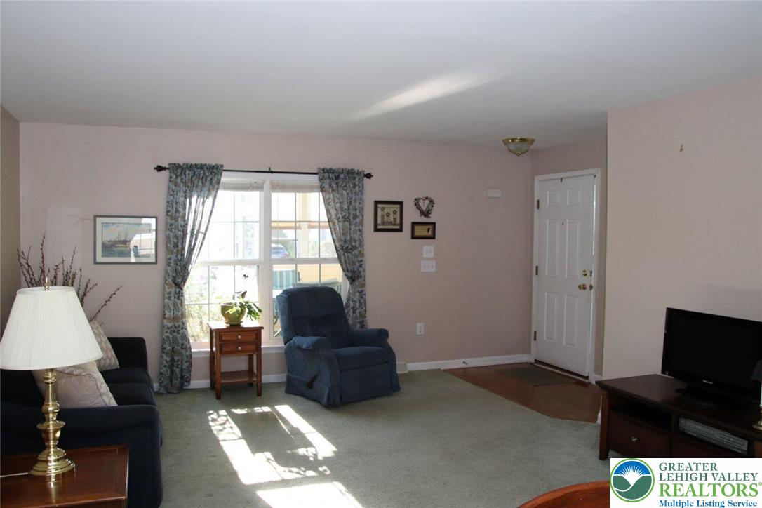 712 Winterthur Way Easton, PA 18040 - Photo 5 of 20 a living room with furniture a flat screen tv and a window