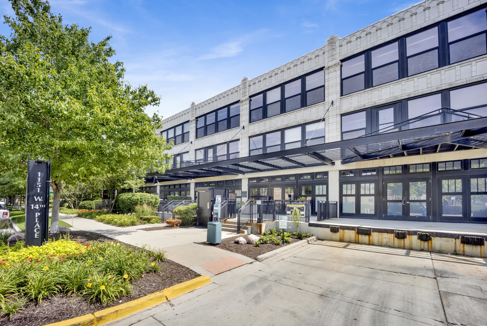 1151 West 14th Place, Unit 209 Chicago, IL 60608 - Photo 1 of 17 a view of a building with a patio