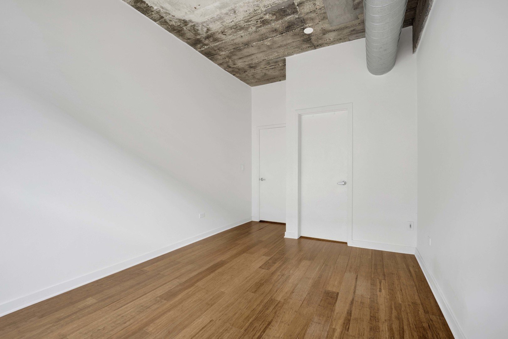 1151 West 14th Place, Unit 209 Chicago, IL 60608 - Photo 11 of 17 a view of wooden floor and utility room