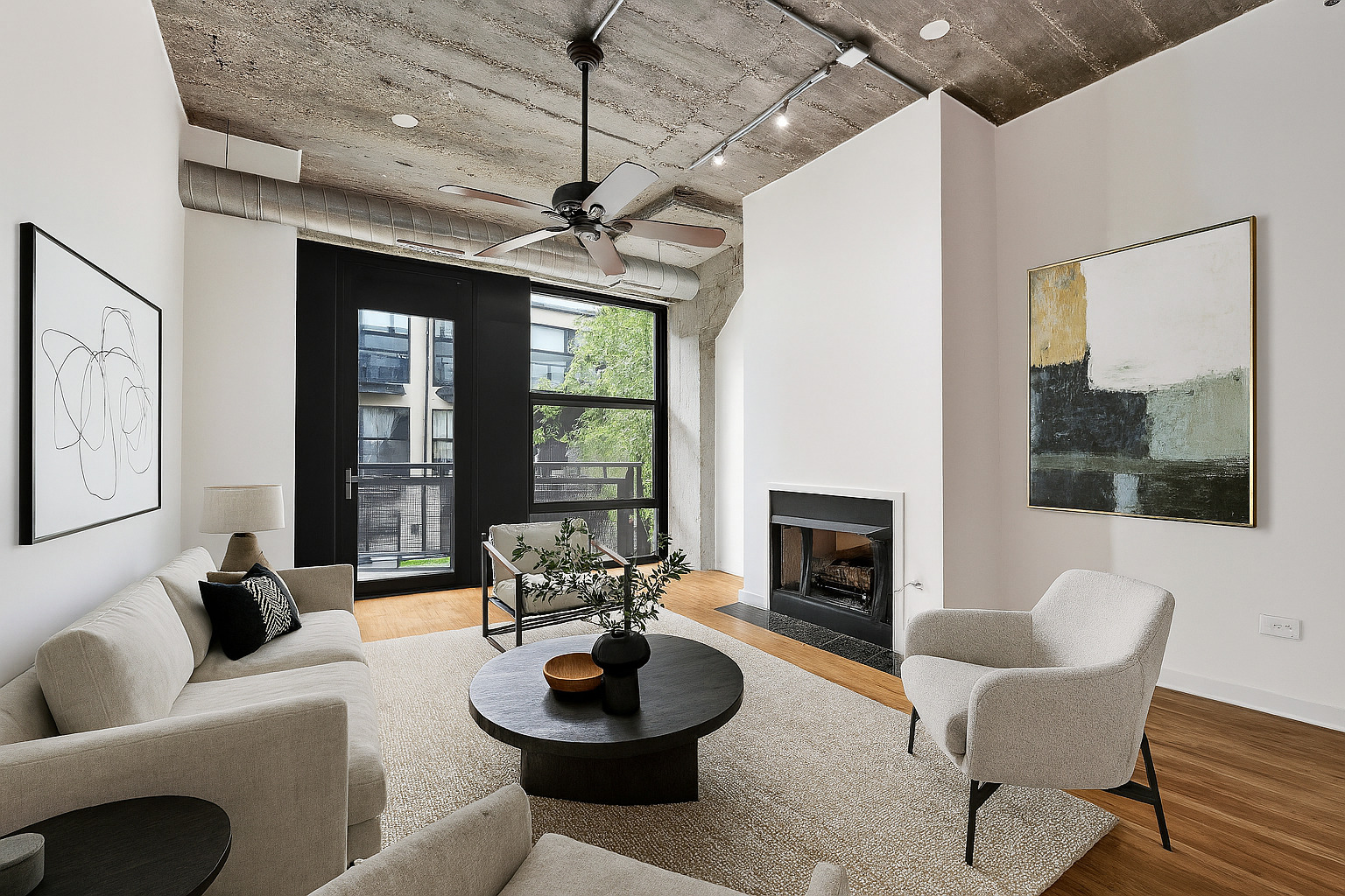 1151 West 14th Place, Unit 209 Chicago, IL 60608 - Photo 2 of 17 a living room with furniture a fireplace and a large window