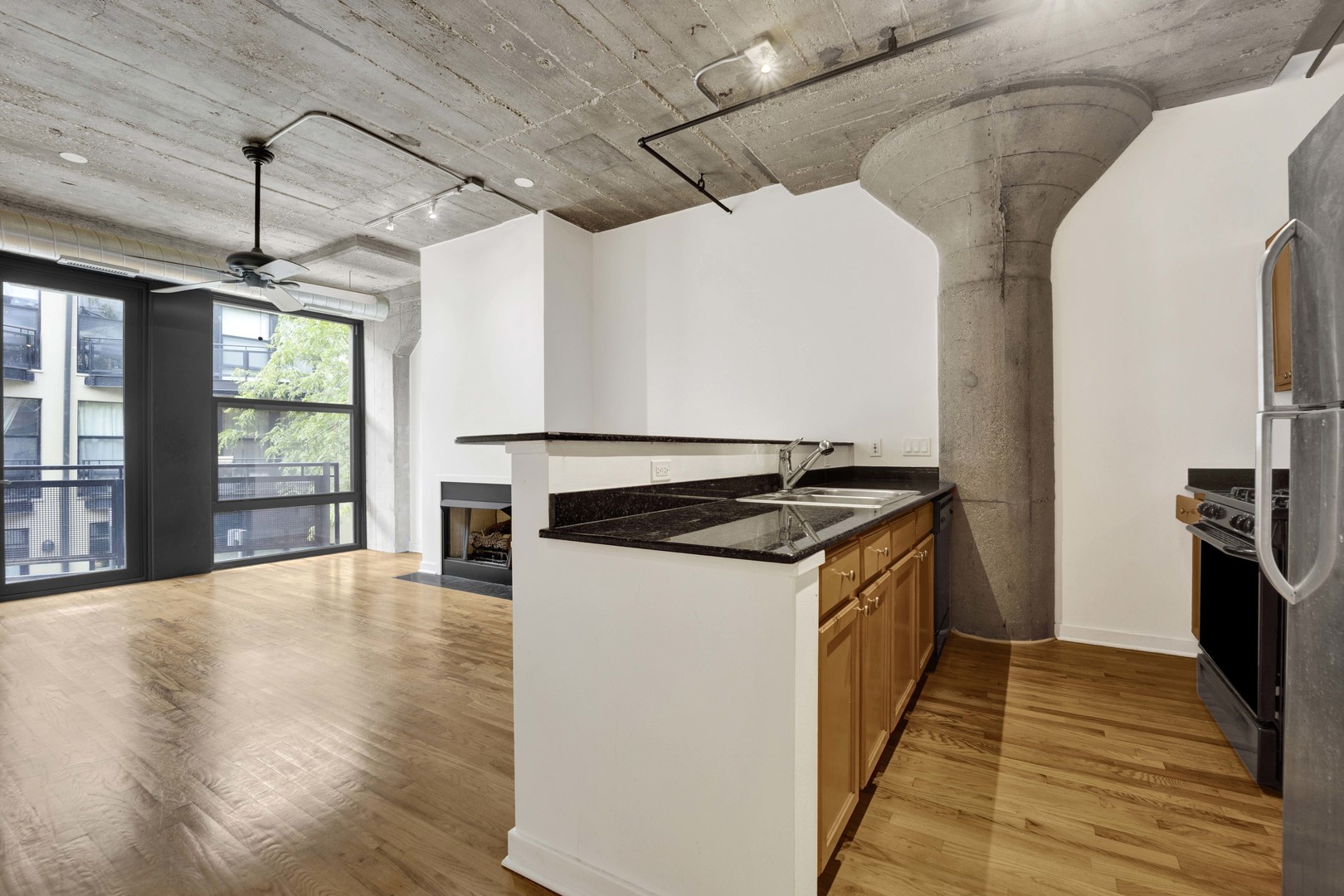 1151 West 14th Place, Unit 209 Chicago, IL 60608 - Photo 3 of 17 a kitchen with a stove and wooden floor