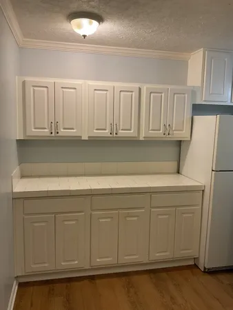 a view of white cabinets and sink