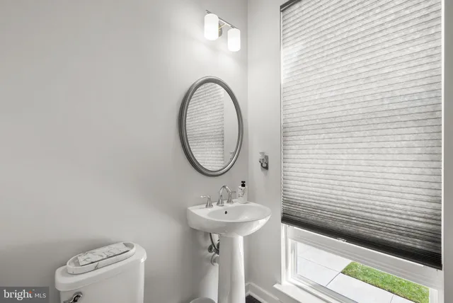 a bathroom with a sink a mirror and a toilet