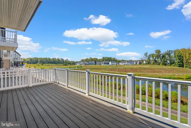 a view of a balcony with wooden floor and city view