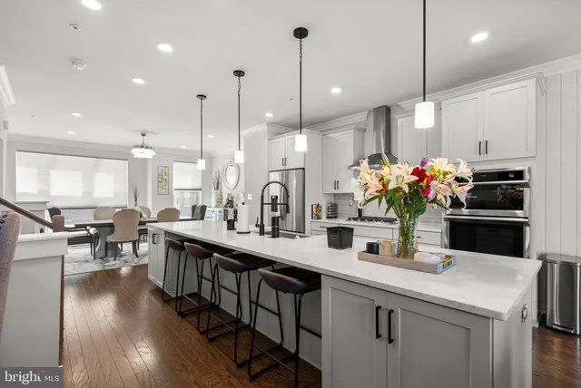 a kitchen with counter top space a sink appliances and cabinets