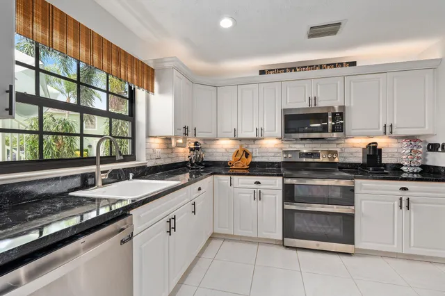 a kitchen with refrigerator and cabinets
