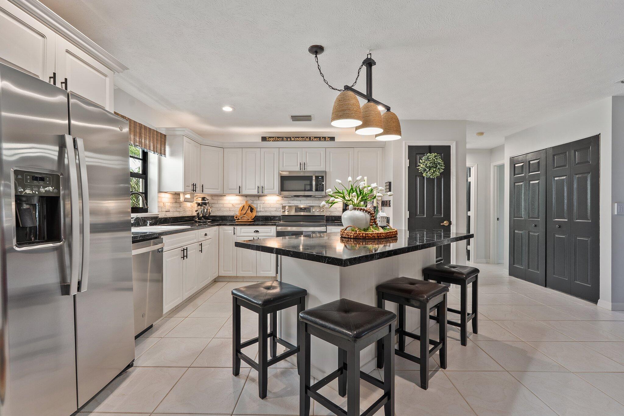 2186 Southeast Wild Meadow Circle Port St. Lucie, FL 34952 - Photo 13 of 57 a kitchen with refrigerator and cabinets