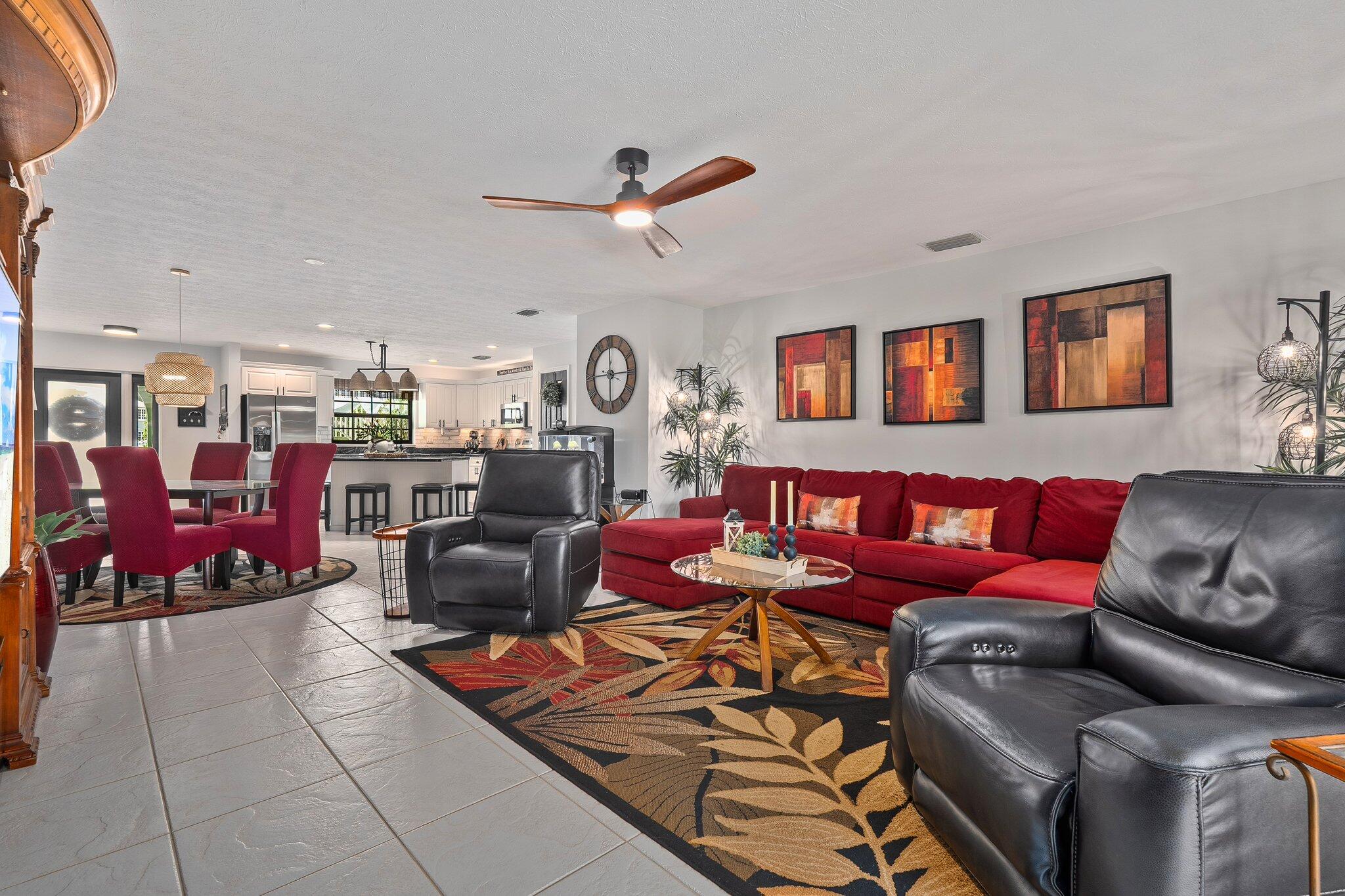 2186 Southeast Wild Meadow Circle Port St. Lucie, FL 34952 - Photo 16 of 57 a living room with furniture gym equipment and a rug